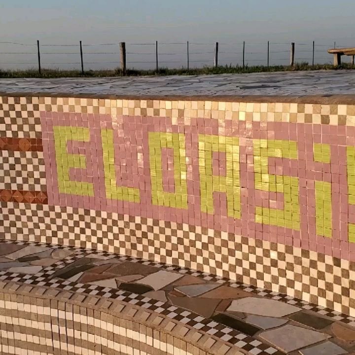 Mosaic with the El Oasis name at the pool