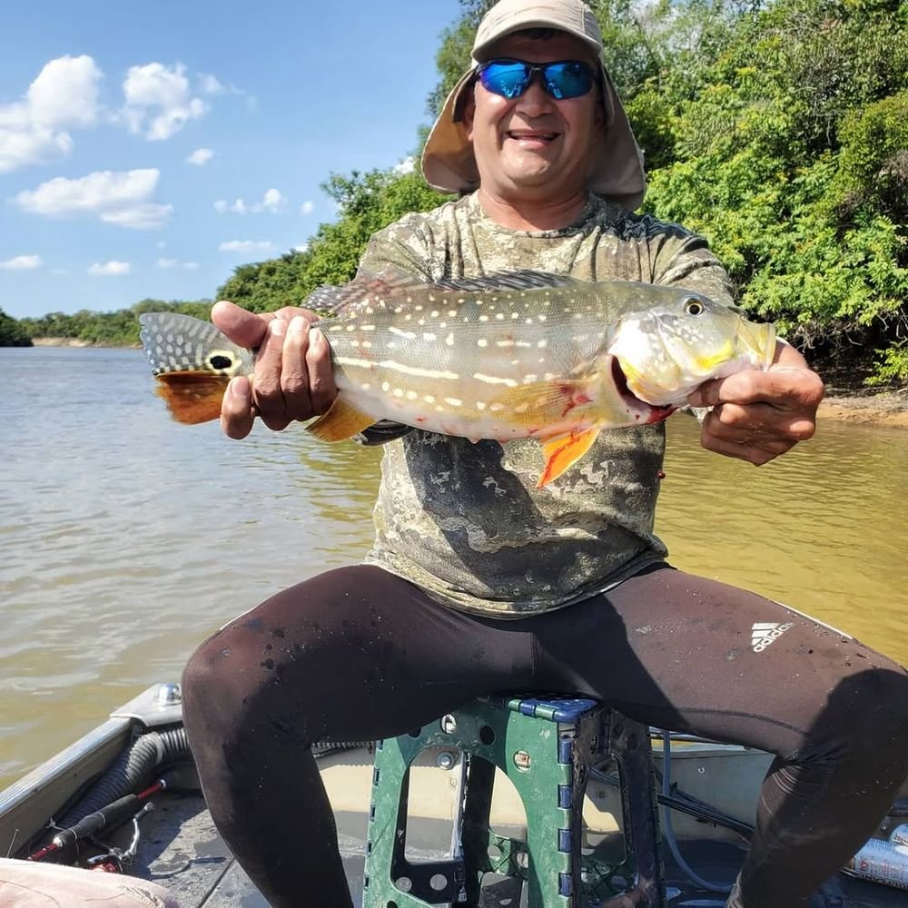 Angler holding his catch on the boat