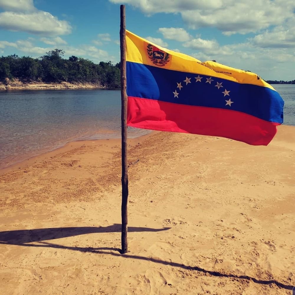 River beach with the Venezuelan flag